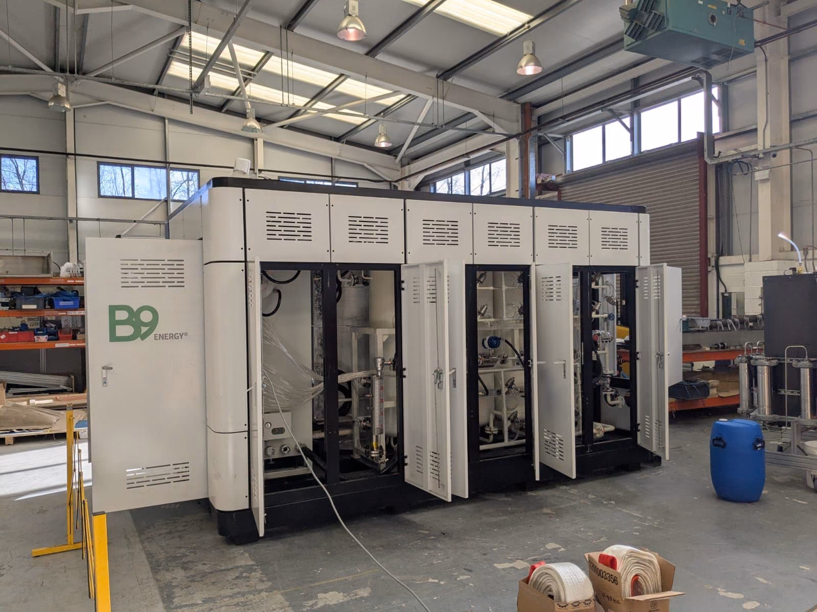 A B9 Energy reformer unit with its cabinet doors open, in a workshop