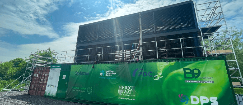 The SmartDAC unit with a banner showing the partners' logos, including B9 Energy Storage and Heriot-Watt University